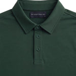 Close-up product view of the green Biome polo collar, buttons and Hampton & Lake neck label.