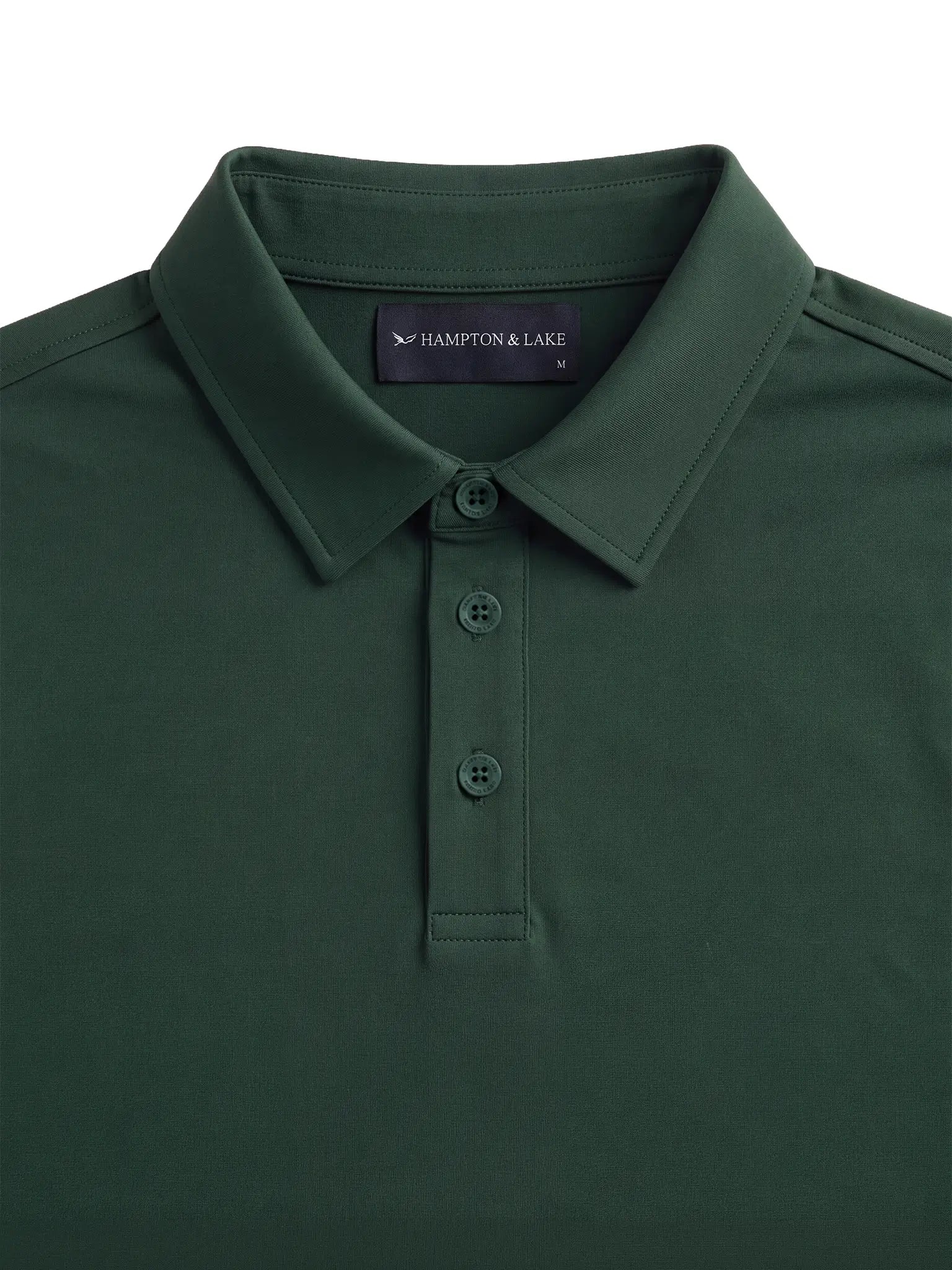 Close-up product view of the green Biome polo collar, buttons and Hampton & Lake neck label.