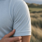 Close-up of the Glacier Biome polo short sleeve and pale blue jersey fabric.