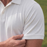 Close-up of the Limestone Biome polo sleeve and chest, showing its off-white jersey texture.