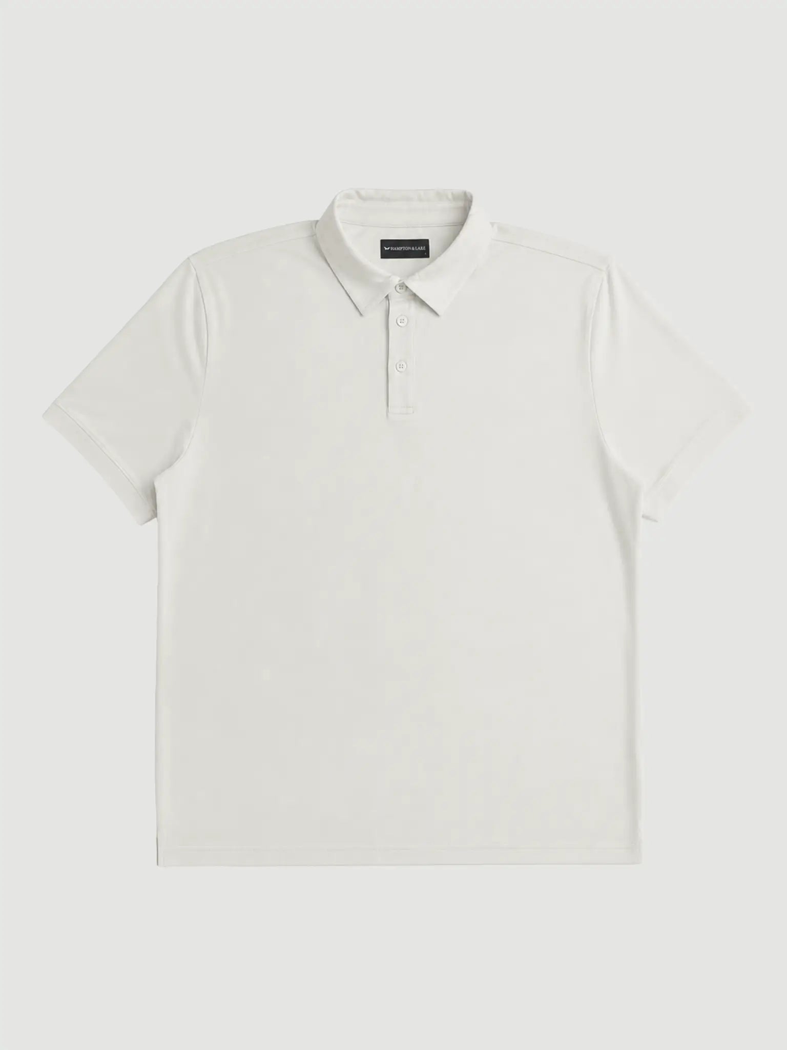 Front product view of the off-white Limestone Biome polo with short sleeves and a button placket.