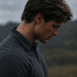 Close-up of the collar and shoulder on the charcoal Volcanic Ash Biome polo.