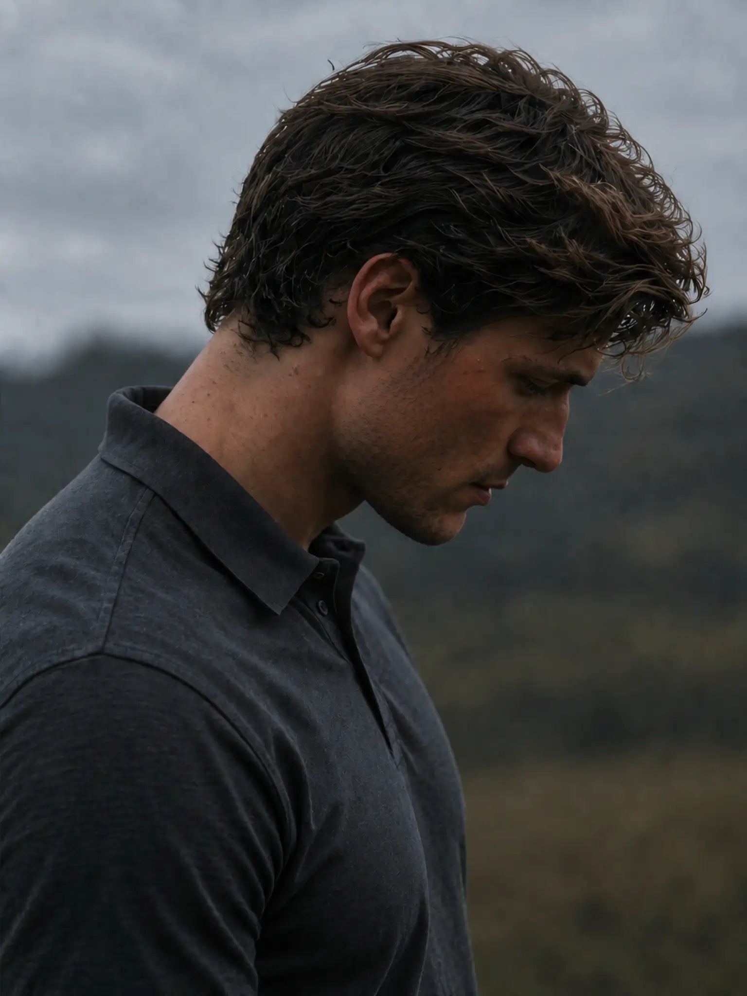Close-up of the collar and shoulder on the charcoal Volcanic Ash Biome polo.
