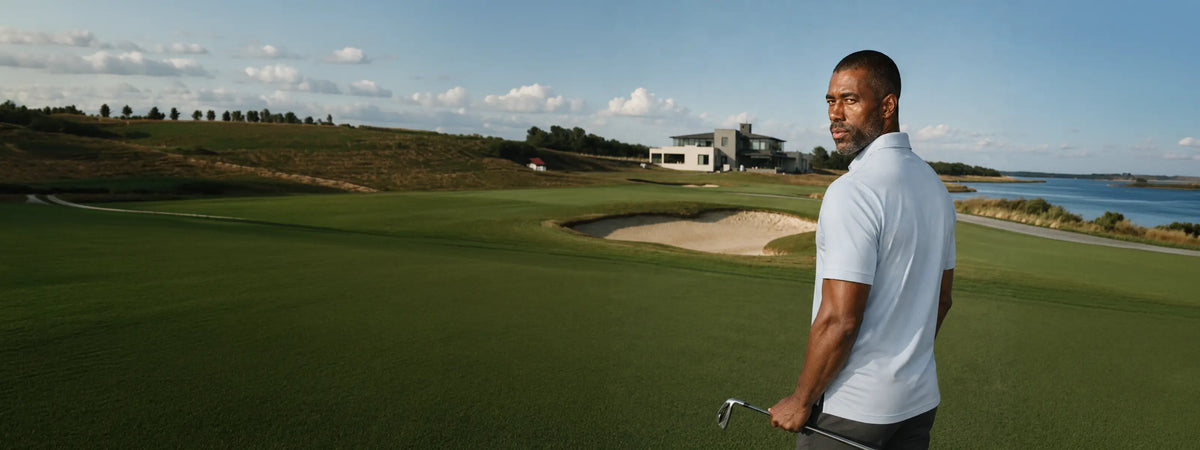 A golfer in a light blue polo on a coastal golf course